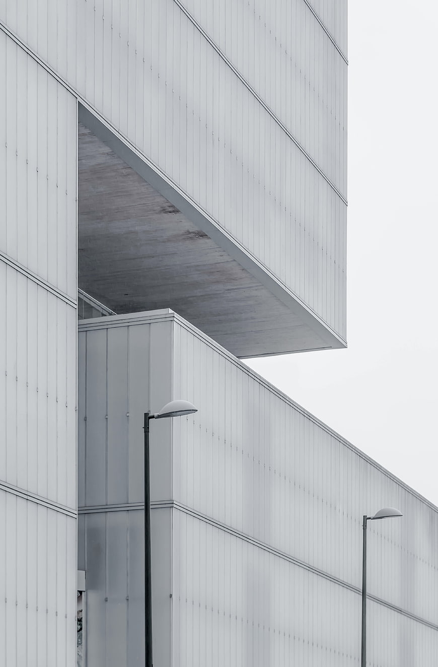 Minimalist modern architecture with white facade and street lamps