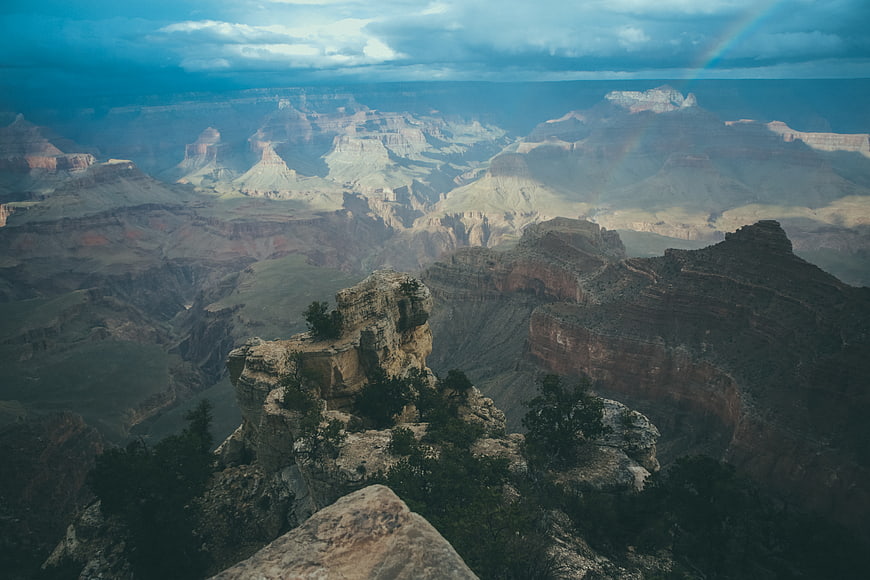 Dramatic Grand Canyon Landscape with Rainbow and Stormy Sky