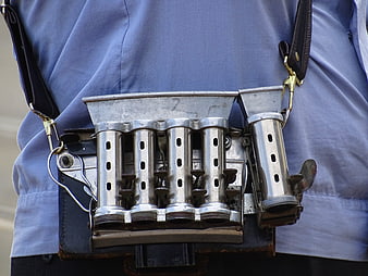 Vintage Metal Coin Dispenser on Blue Uniform