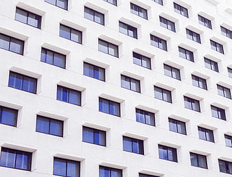 White modern building facade with repeating window pattern