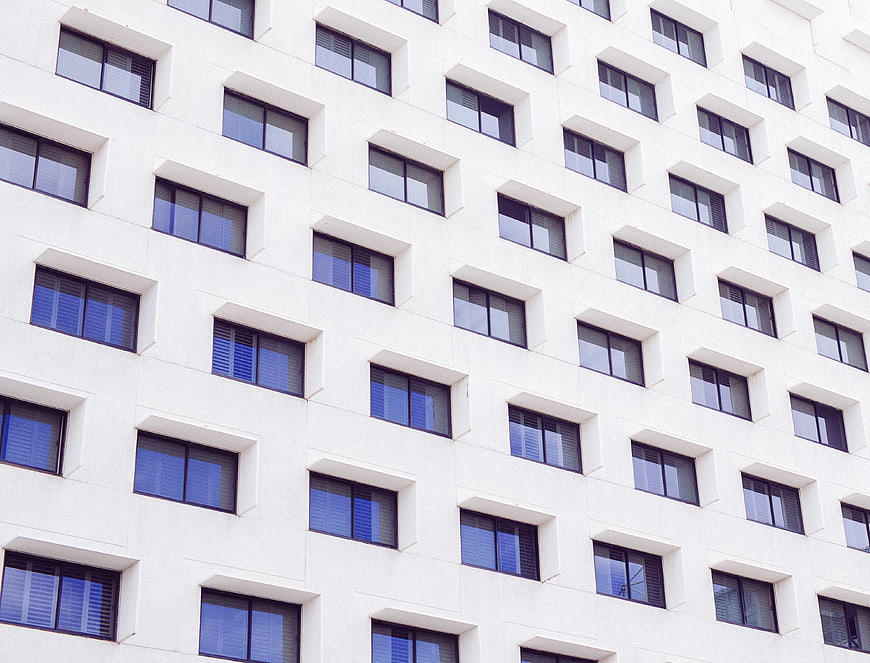 White modern building facade with repeating window pattern