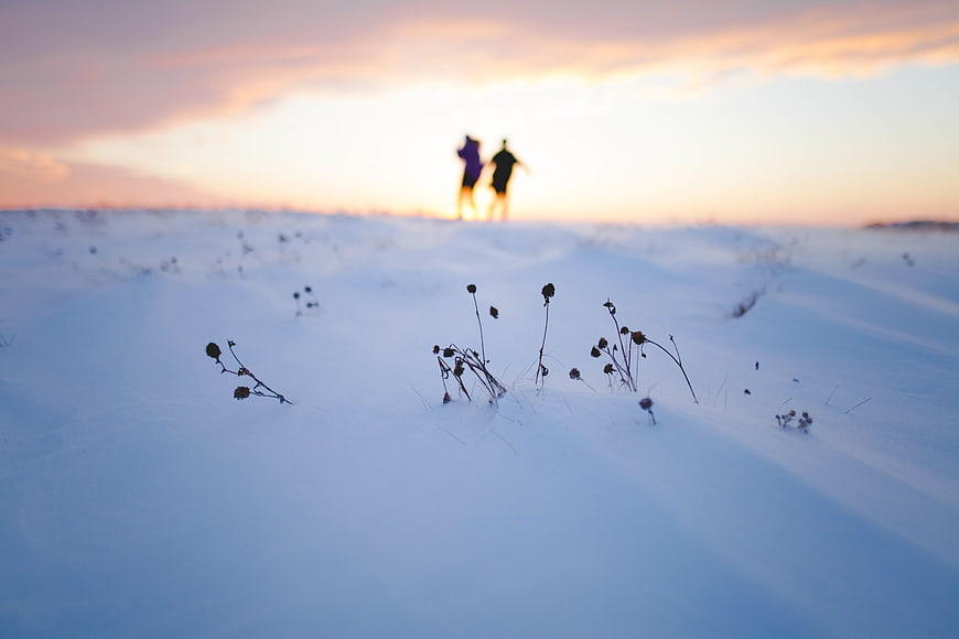 Blurred Silhouette of Couple Walking in Snowy Winter Landscape