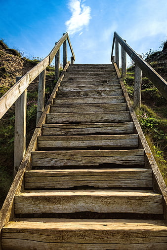Weathered Wooden Staircase Leading Up To Blue Sky