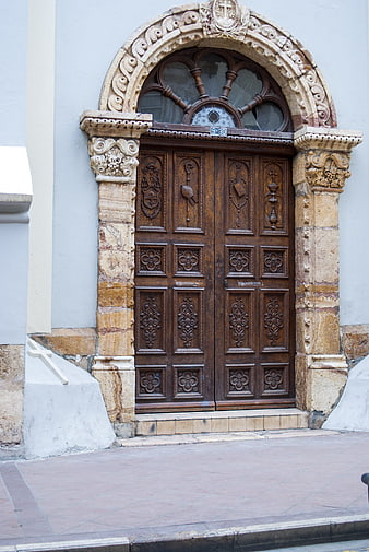 Ornate wooden church door with stone archway