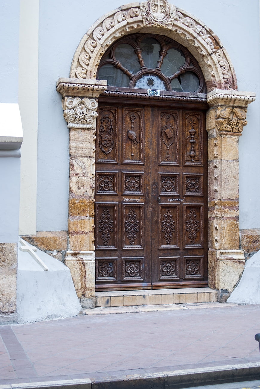 Ornate wooden church door with stone archway