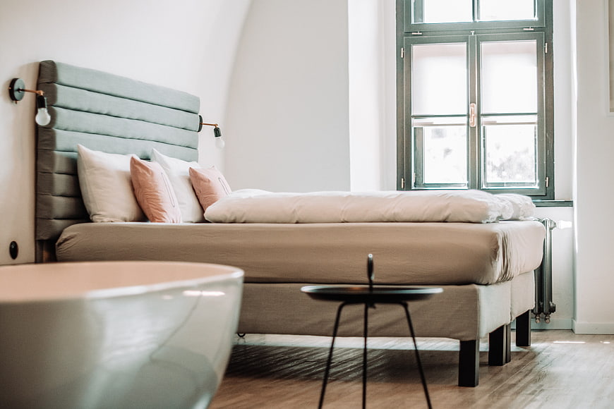 Modern Bedroom Interior With Teal Headboard And White Bathtub