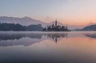 Serene Lake Bled Island Reflection at Sunrise with Mist