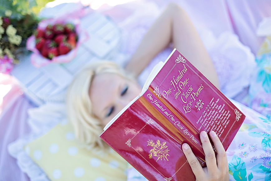 Woman Reading Classic Love Poems on Bed