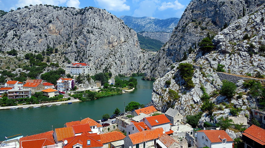 Aerial View of Town with Orange Roofs in River Canyon