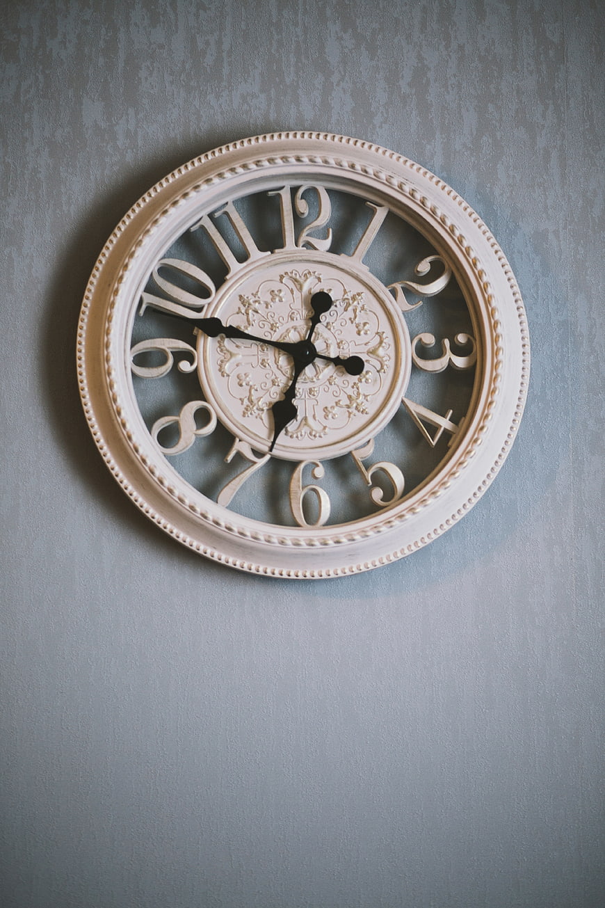 Vintage Cream Wall Clock on Textured Blue Wall