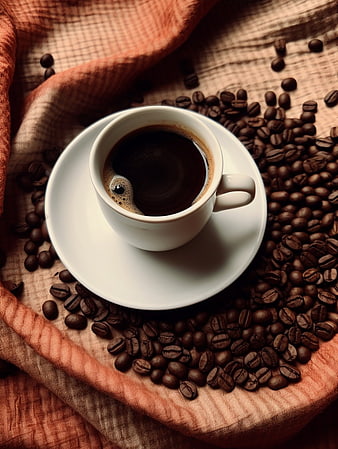 Top View of Black Coffee Cup Surrounded by Roasted Beans