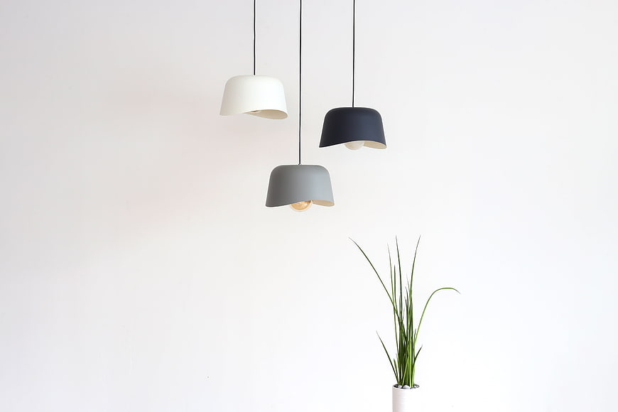 Minimalist Pendant Lights With Potted Plant Against White Wall