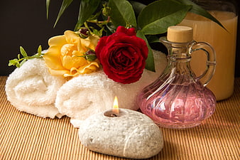 Spa Wellness Still Life With Roses, Towels, Candle, And Oil Carafe