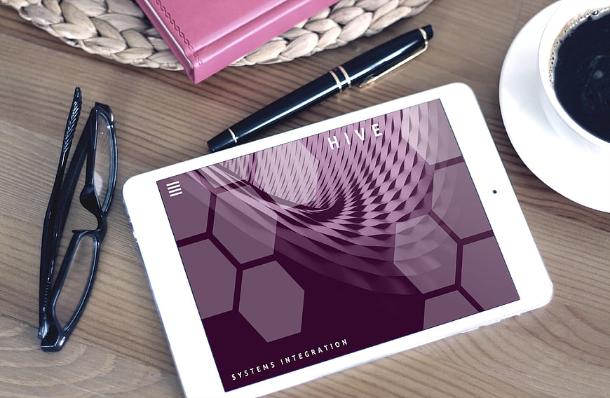 Tablet displaying purple honeycomb design on wooden desk with coffee
