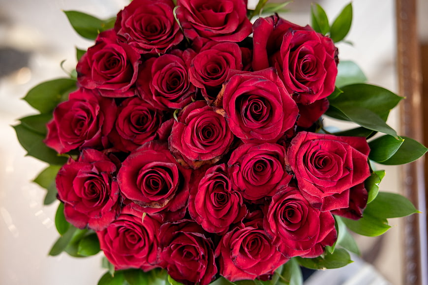 Top View of Vibrant Red Rose Bouquet with Green Leaves