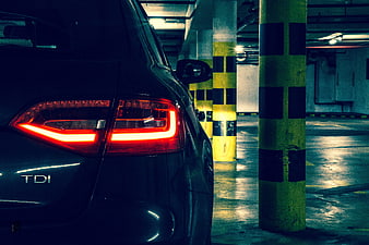Rear View of Audi A4 TDI with Glowing Taillights in Underground Parking Garage