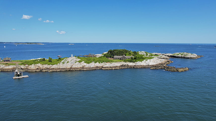 Aerial View of Rocky Coastal Island with Blue Ocean