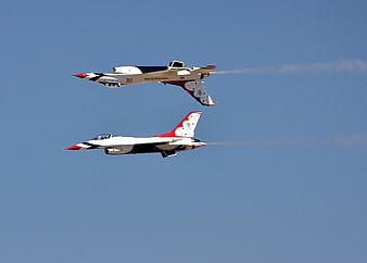 Two Red, White, and Blue Jets Flying in Formation