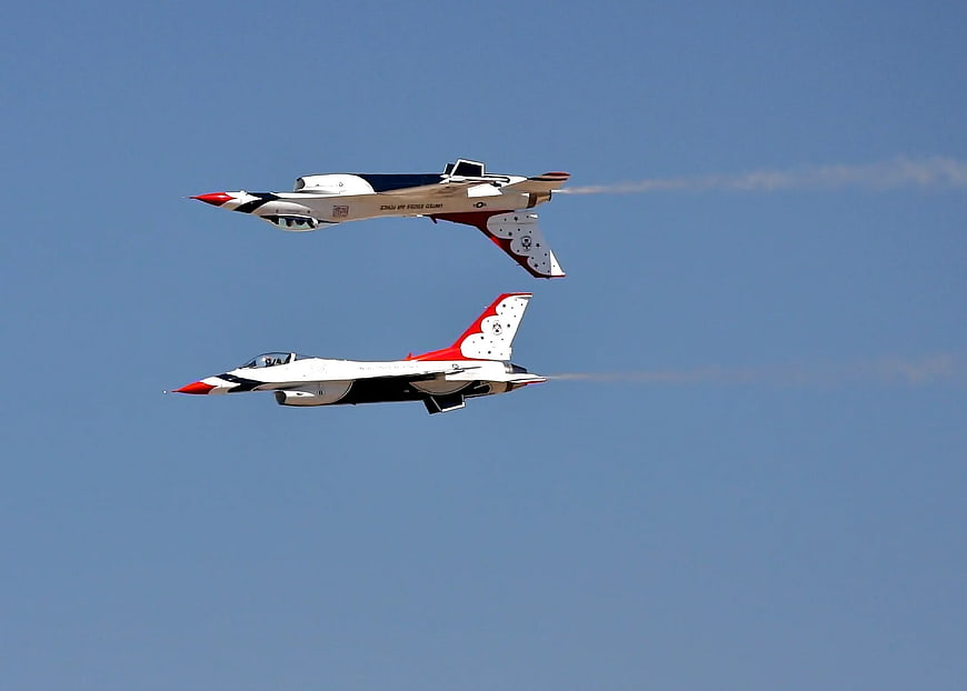 Two Red, White, and Blue Jets Flying in Formation