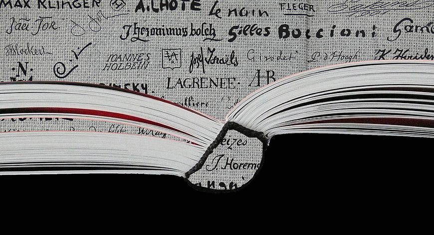 Close-up of open book pages with handwritten names background