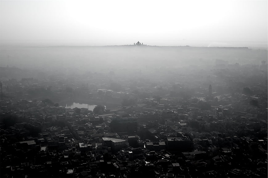 Aerial black and white view of city skyline in thick fog