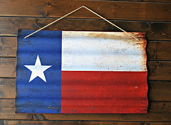 Vintage Texas Flag on Rusty Metal Sign Hanging on Wood