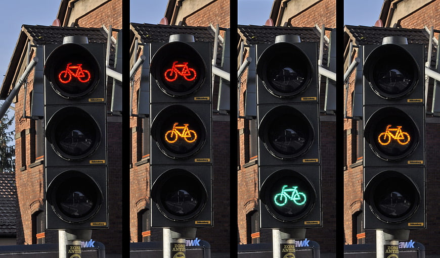 Sequence of bicycle traffic light signals showing red, amber, and green phases