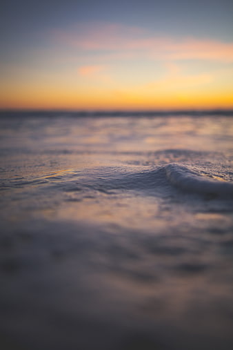 Soft Focus Ocean Waves at Sunset with Blurred Horizon