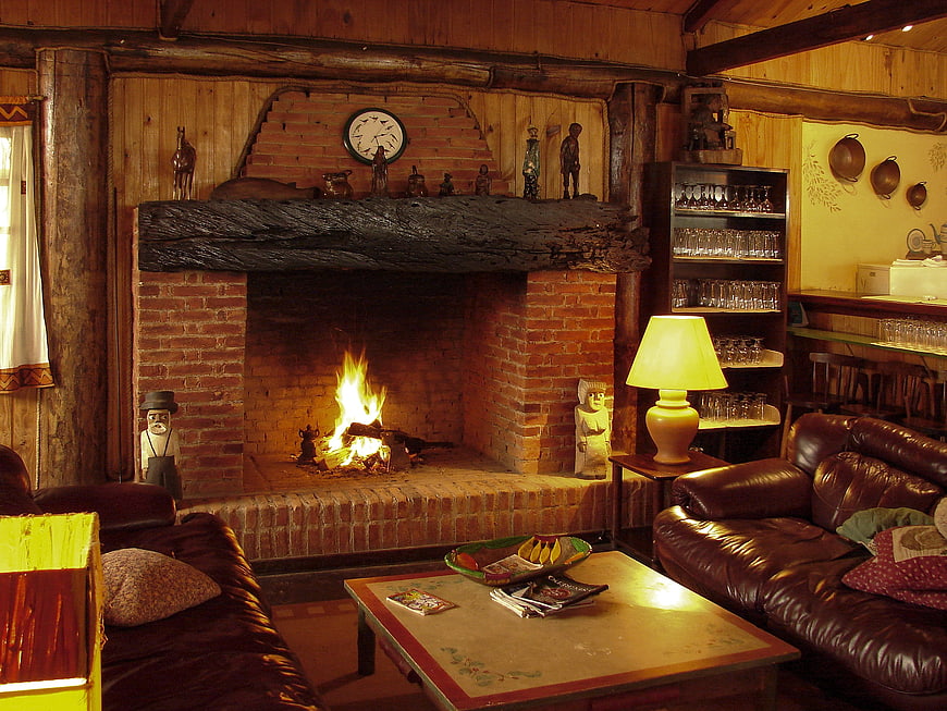 Cozy rustic living room with brick fireplace and leather sofa