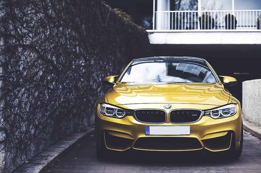 Front View of Yellow BMW M4 Coupe Parked on Urban Street