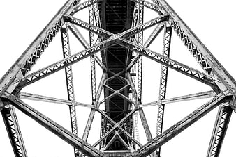 Black and white worm's eye view of steel bridge truss structure