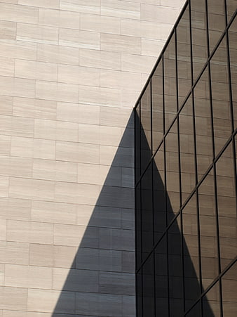 Modern architectural facade with sharp geometric shadow