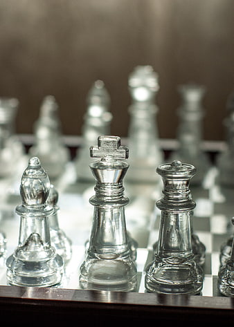 Glass Chess Pieces on Board with Shallow Depth of Field
