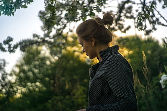 Contemplative Woman in Nature with Bokeh Background