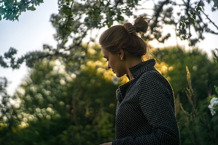 Contemplative Woman in Nature with Bokeh Background