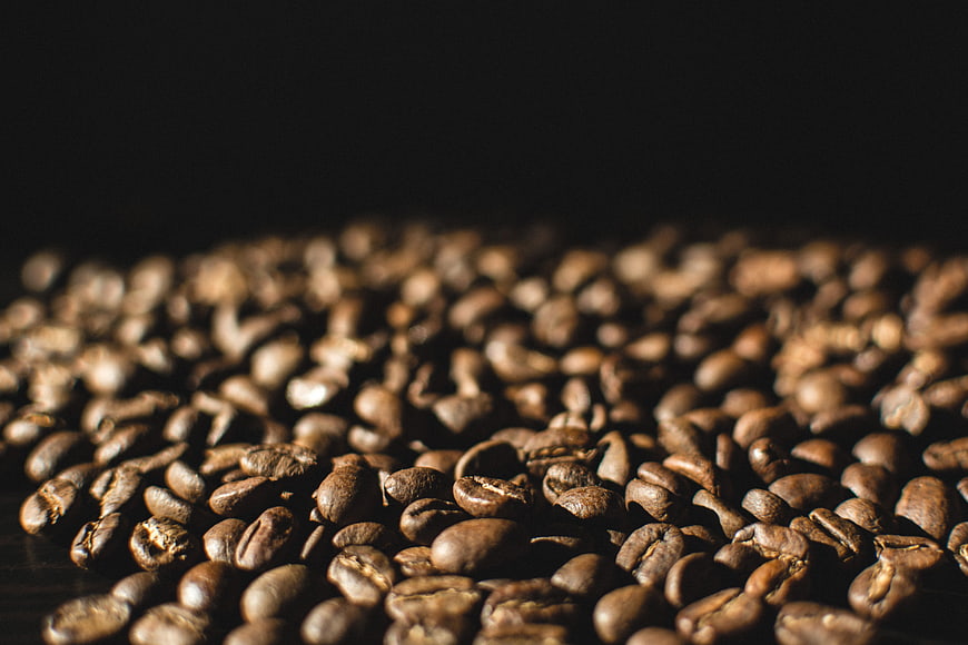 Close-up of roasted coffee beans on dark background