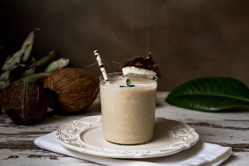 Creamy Coconut Smoothie with Fresh Garnish on Rustic Table