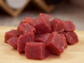 Fresh Raw Beef Cubes on Wooden Cutting Board