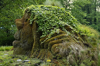 Mossy Stone Troll Sculpture in Lush Forest Garden