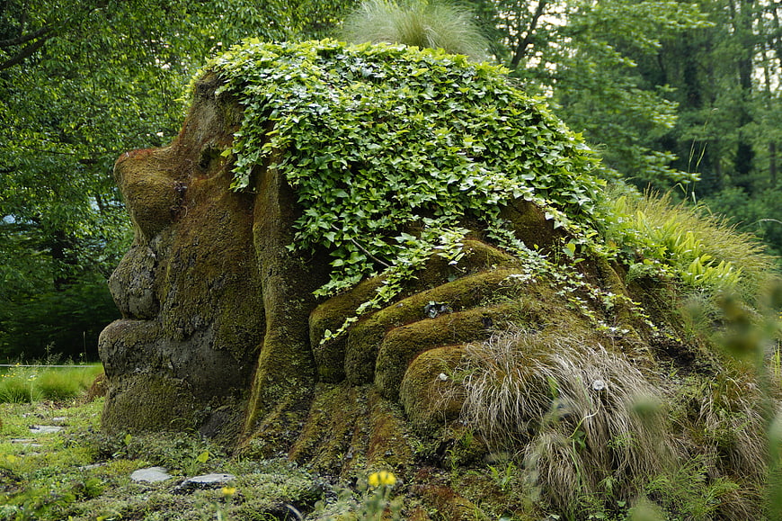 Mossy Stone Troll Sculpture in Lush Forest Garden