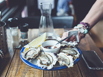 Fresh Oysters on Blue Plate with Lemon and Mignonette Sauce