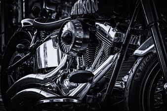 Black and white close-up of a Harley Davidson motorcycle engine and chrome details