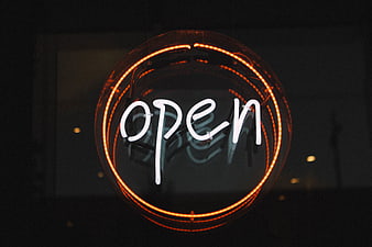 Glowing Neon Open Sign in Dark Window