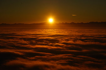 Golden Sunrise Over Sea of Clouds and Mountain Silhouette