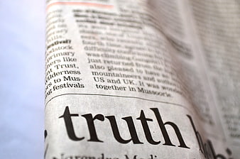 Close-up of the word truth printed on a newspaper page