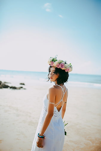 Woman in White Dress with Flower Crown on Beach