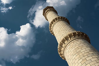 Low angle view of Taj Mahal minaret against blue sky