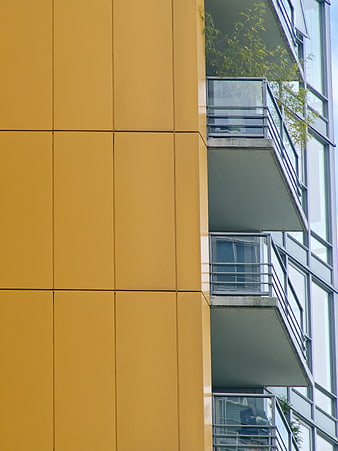 Modern Yellow Apartment Building Facade with Balconies