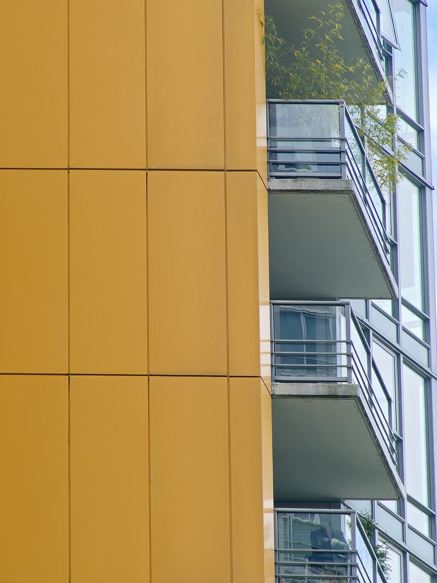 Modern Yellow Apartment Building Facade with Balconies