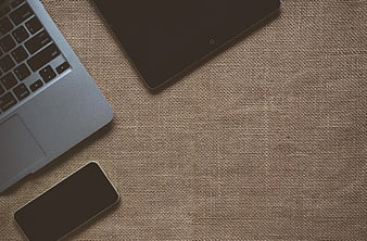Laptop, Tablet, and Smartphone on Textured Fabric Background